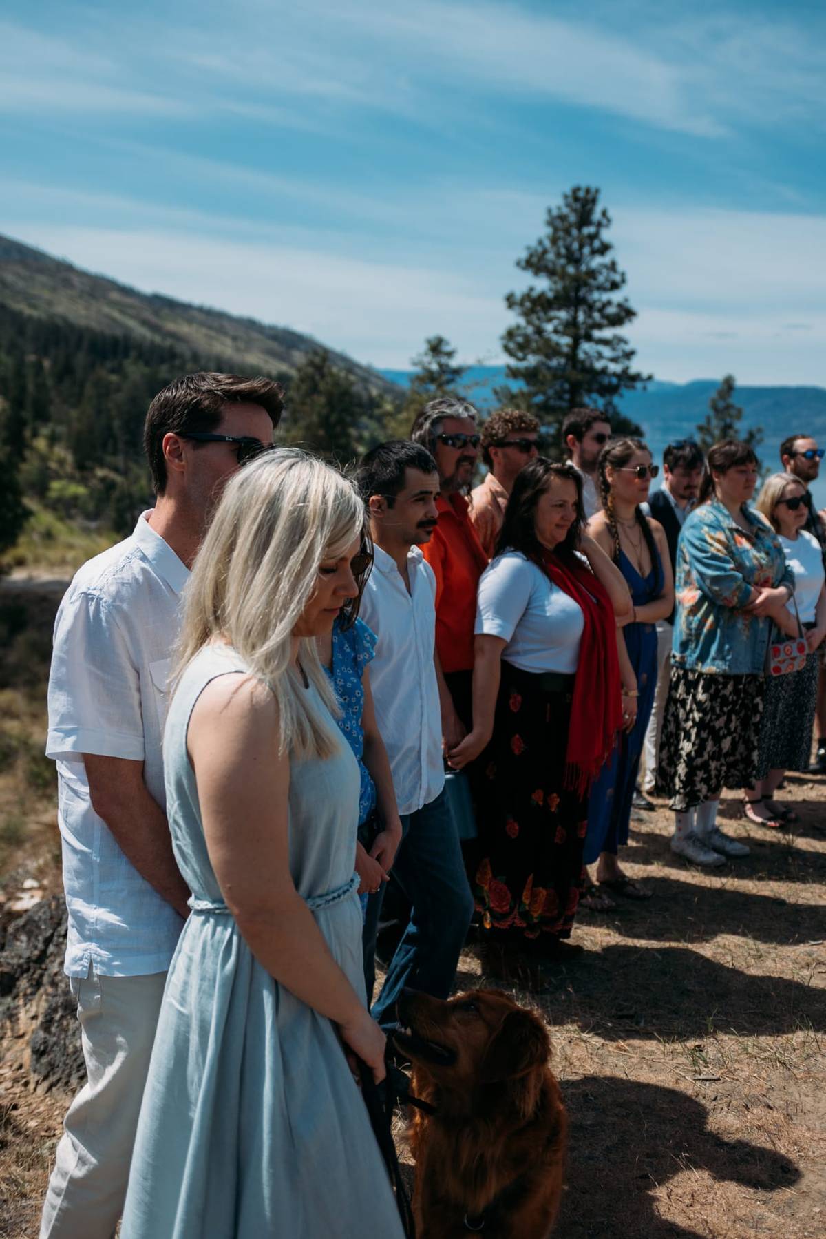 Wedding guests gathered outdoors in bright Okanagan light