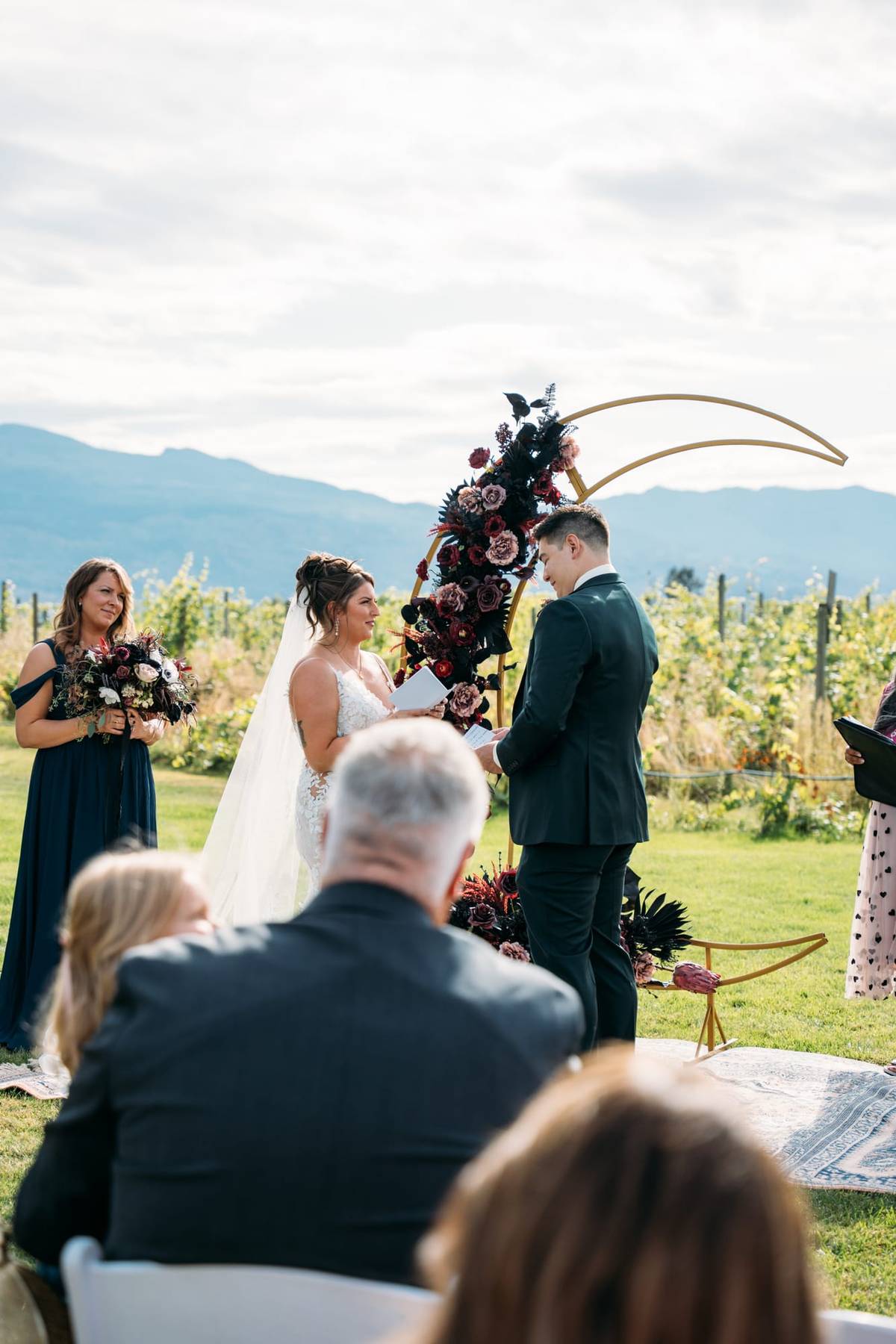 Bride and groom under an outdoor Okanagan wedding arch
