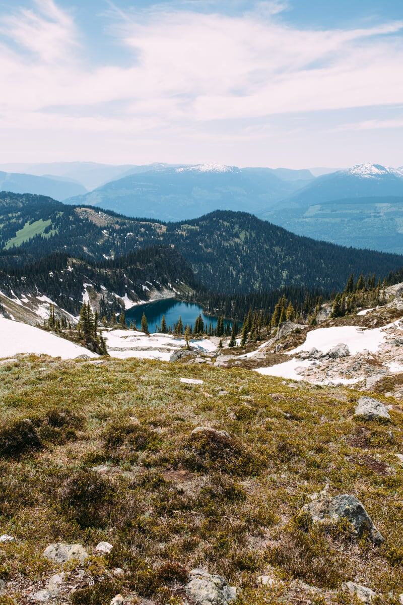 Alpine meadow, snow patches and distant blue ridges in Mount Revelstoke. print option