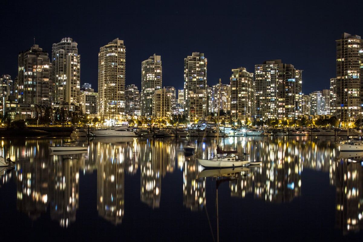 Vancouver towers reflect in black water at night. print option