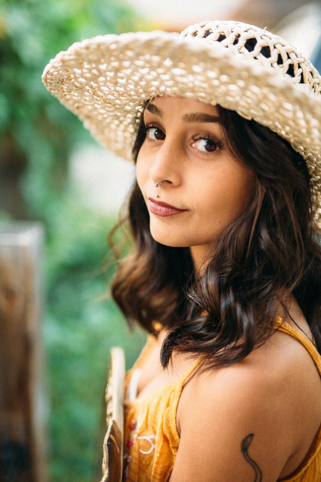 Angelica in Garden Light story frame 11: An earlier portrait story with garden colour, mirror play, straw-hat frames and window light.