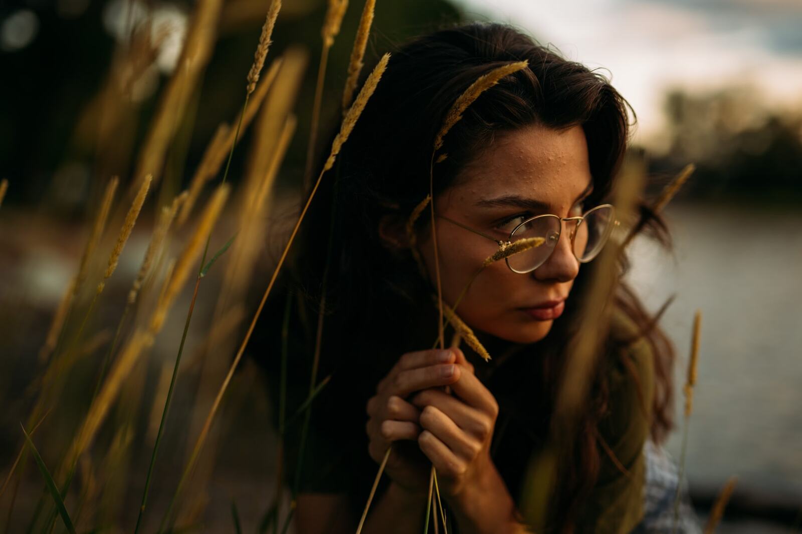 Mel, Summer 2019 story frame 3: A 2019 portrait archive story with bubbles, reeds, glasses and warm dusk colour.