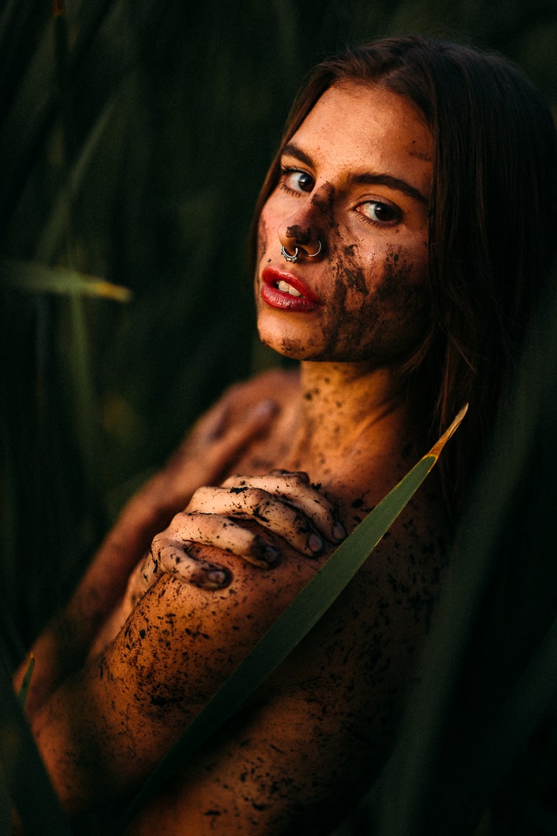 Mo in the Reeds story frame 6: A 2019 portrait archive story in reeds, body paint, low sun and green shadow.