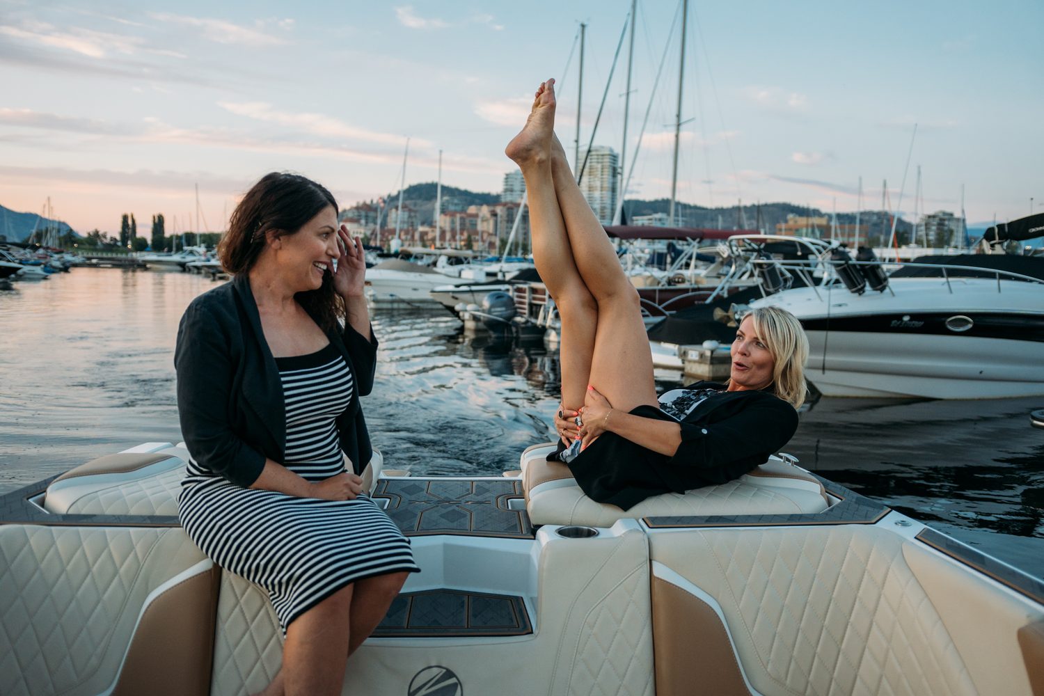 Let's Not Sugarcoat It, Summer corporate story frame 36: A summer business-portrait set for Let's Not Sugarcoat It: docks, colour, boat light and two women making room for conversations that are direct, raw and public..