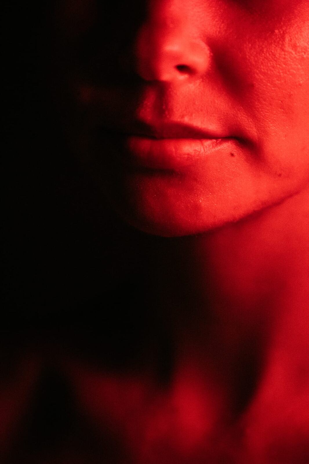 Angela at Float Space portraits story frame 6: A Float Space portrait set that moves from clean wellness headshots into red low-key portraits, skin, shadow and close detail.