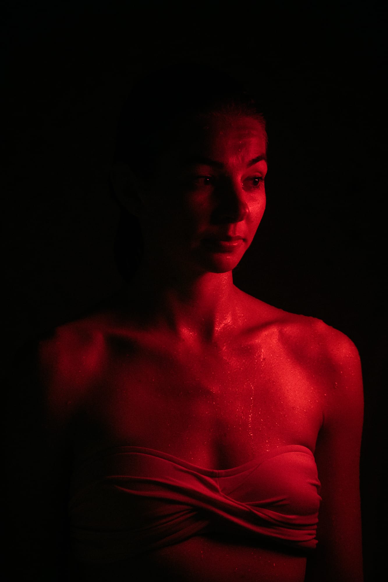 Angela at Float Space portraits story frame 10: A Float Space portrait set that moves from clean wellness headshots into red low-key portraits, skin, shadow and close detail..