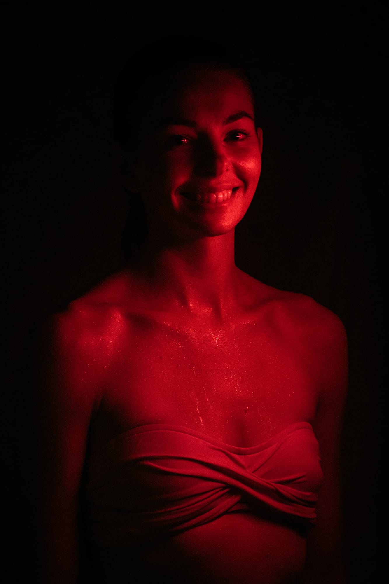 Angela at Float Space portraits story frame 13: A Float Space portrait set that moves from clean wellness headshots into red low-key portraits, skin, shadow and close detail..