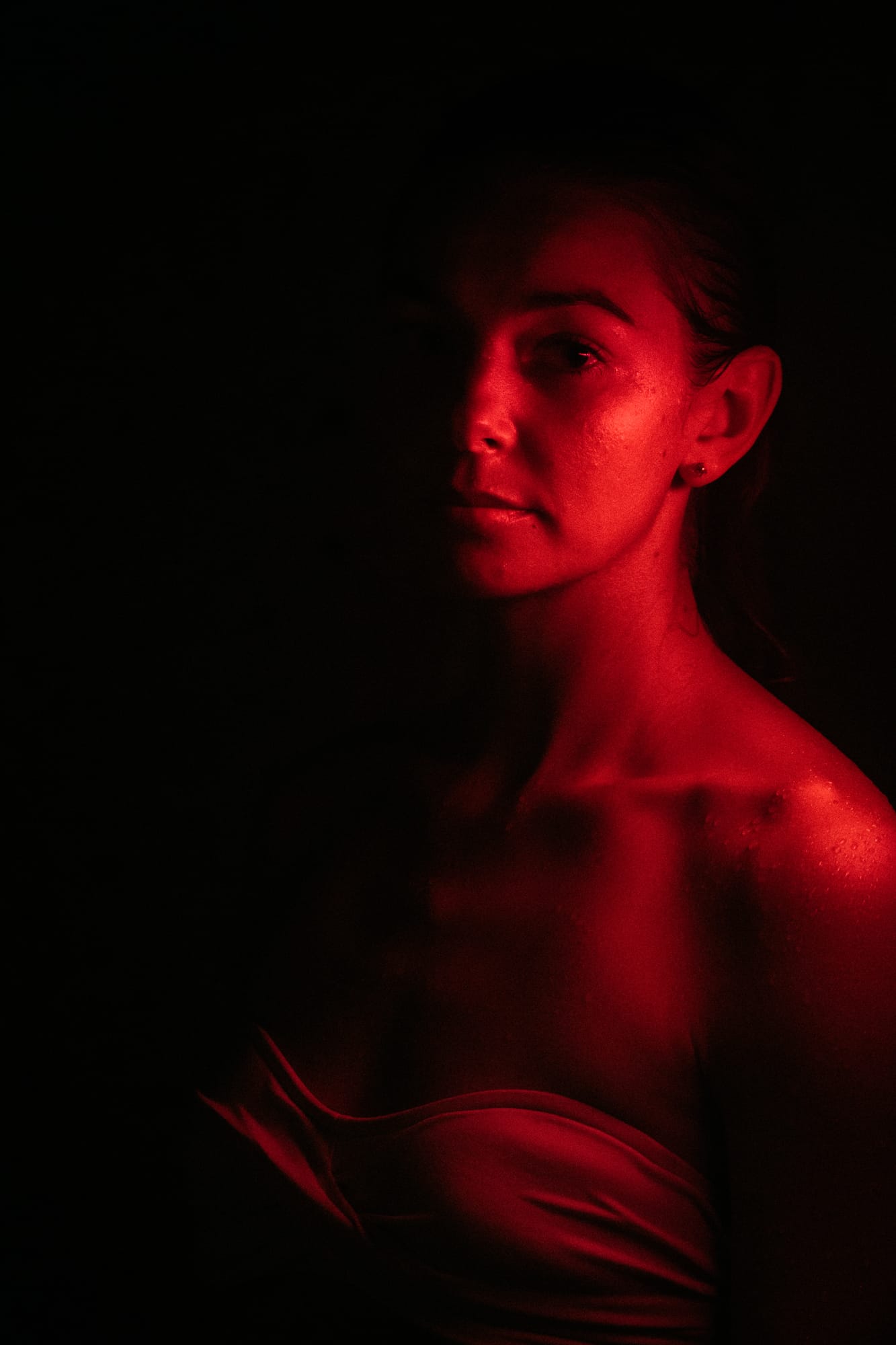 Angela at Float Space portraits story frame 15: A Float Space portrait set that moves from clean wellness headshots into red low-key portraits, skin, shadow and close detail..