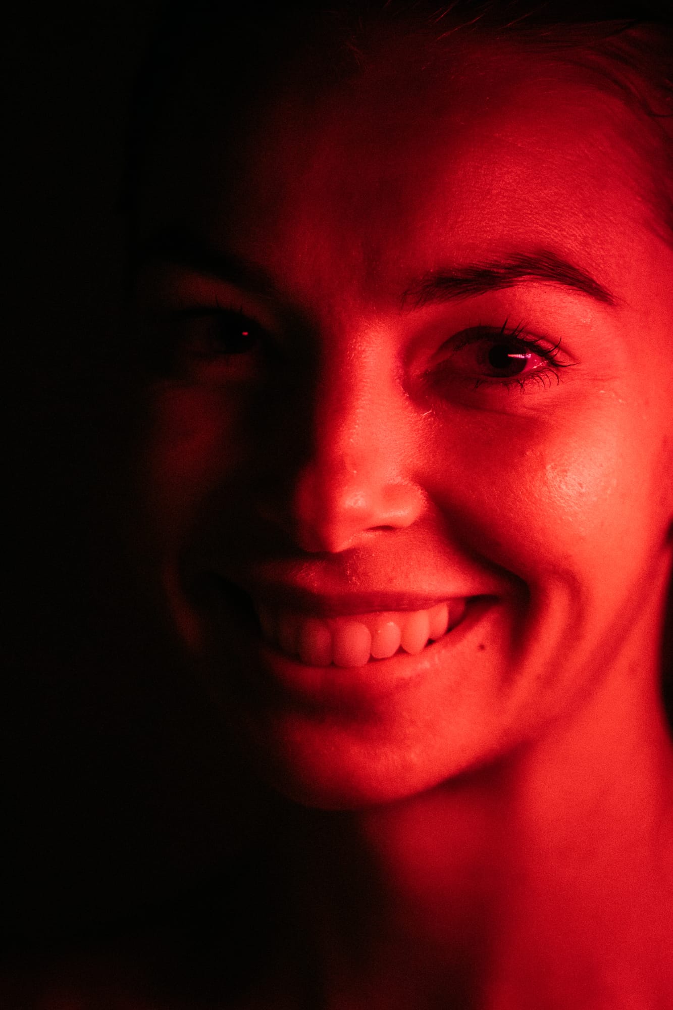 Angela at Float Space portraits story frame 17: A Float Space portrait set that moves from clean wellness headshots into red low-key portraits, skin, shadow and close detail..
