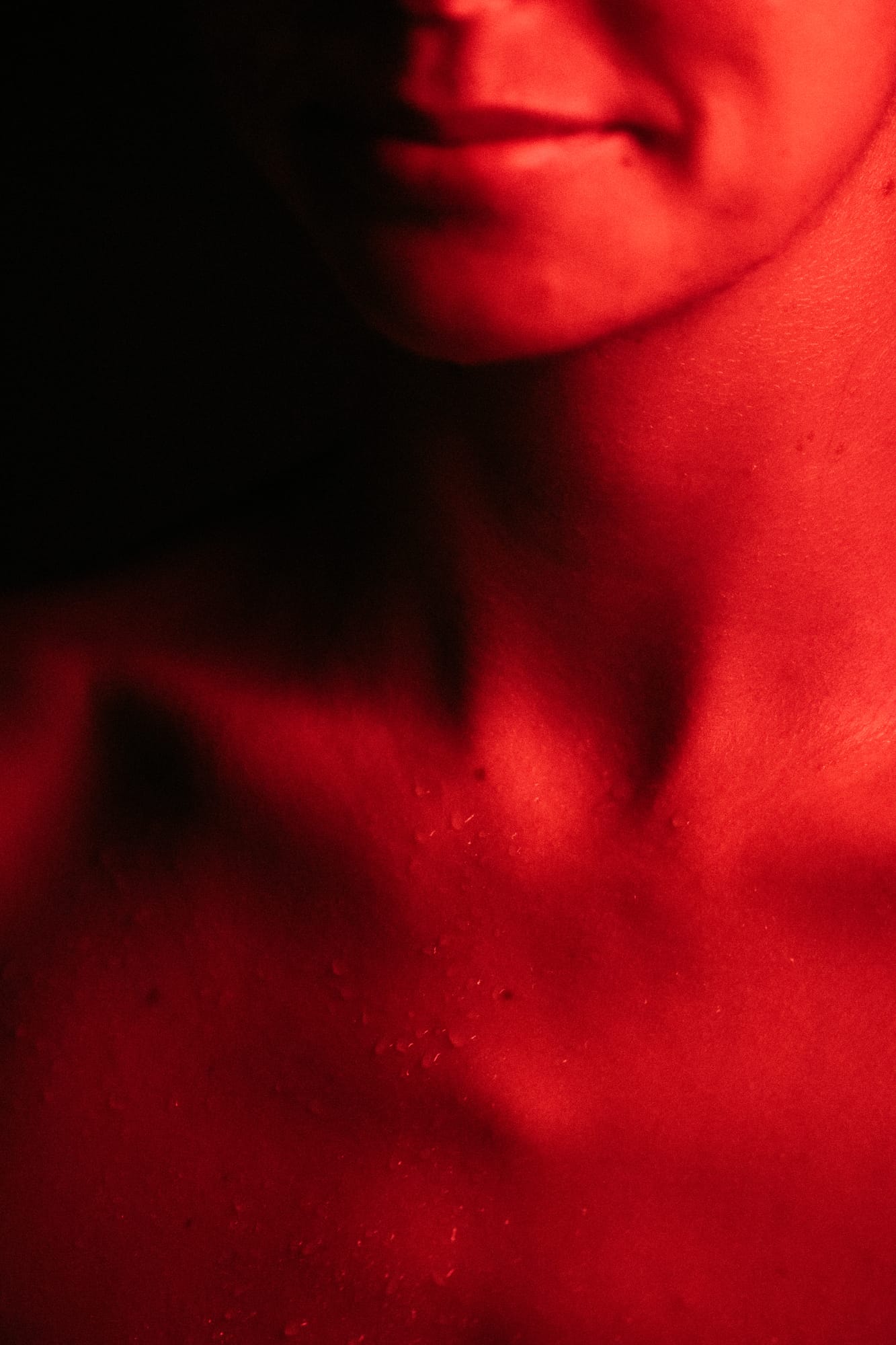 Angela at Float Space portraits story frame 19: A Float Space portrait set that moves from clean wellness headshots into red low-key portraits, skin, shadow and close detail..