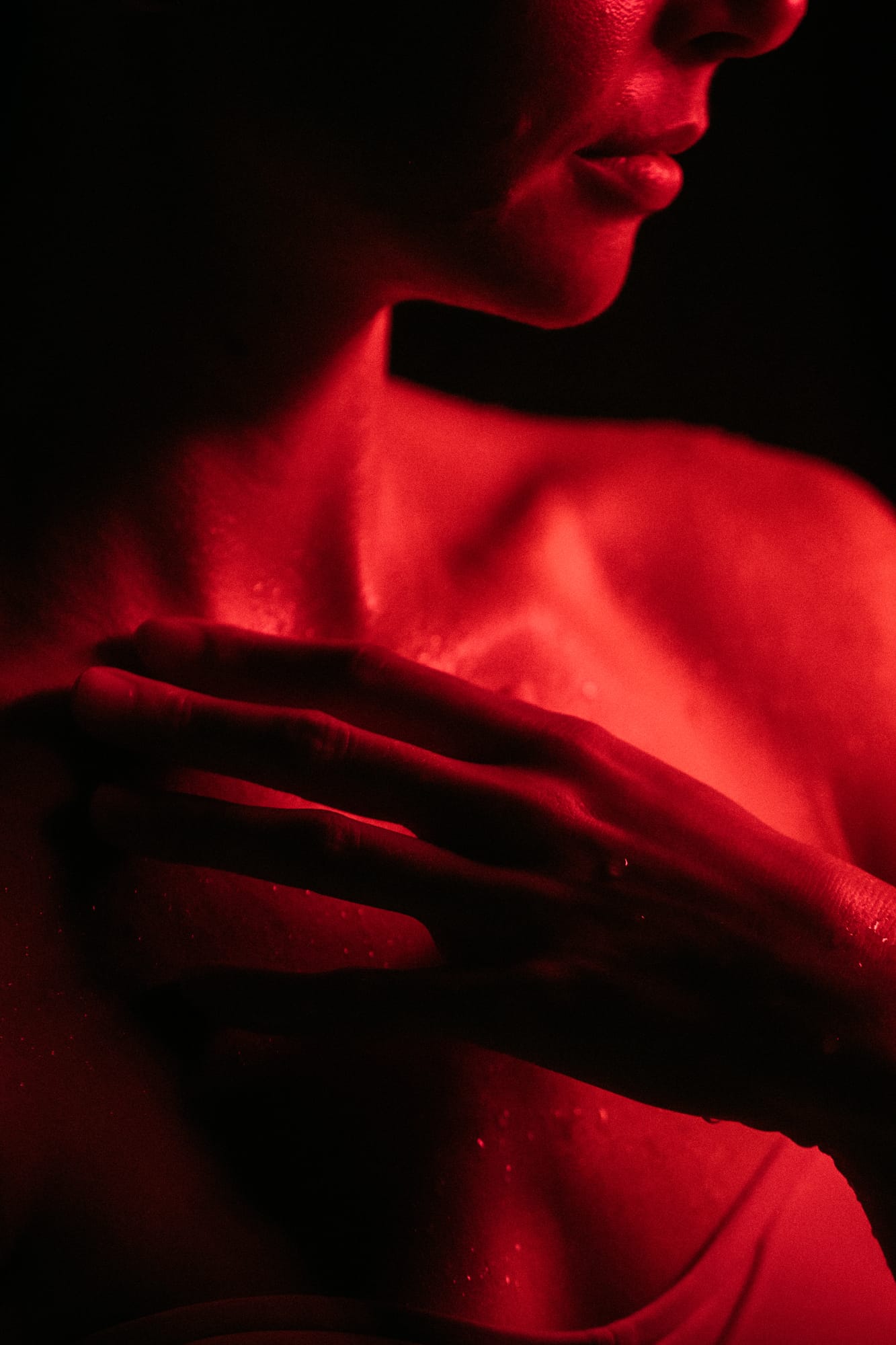 Angela at Float Space portraits story frame 21: A Float Space portrait set that moves from clean wellness headshots into red low-key portraits, skin, shadow and close detail..
