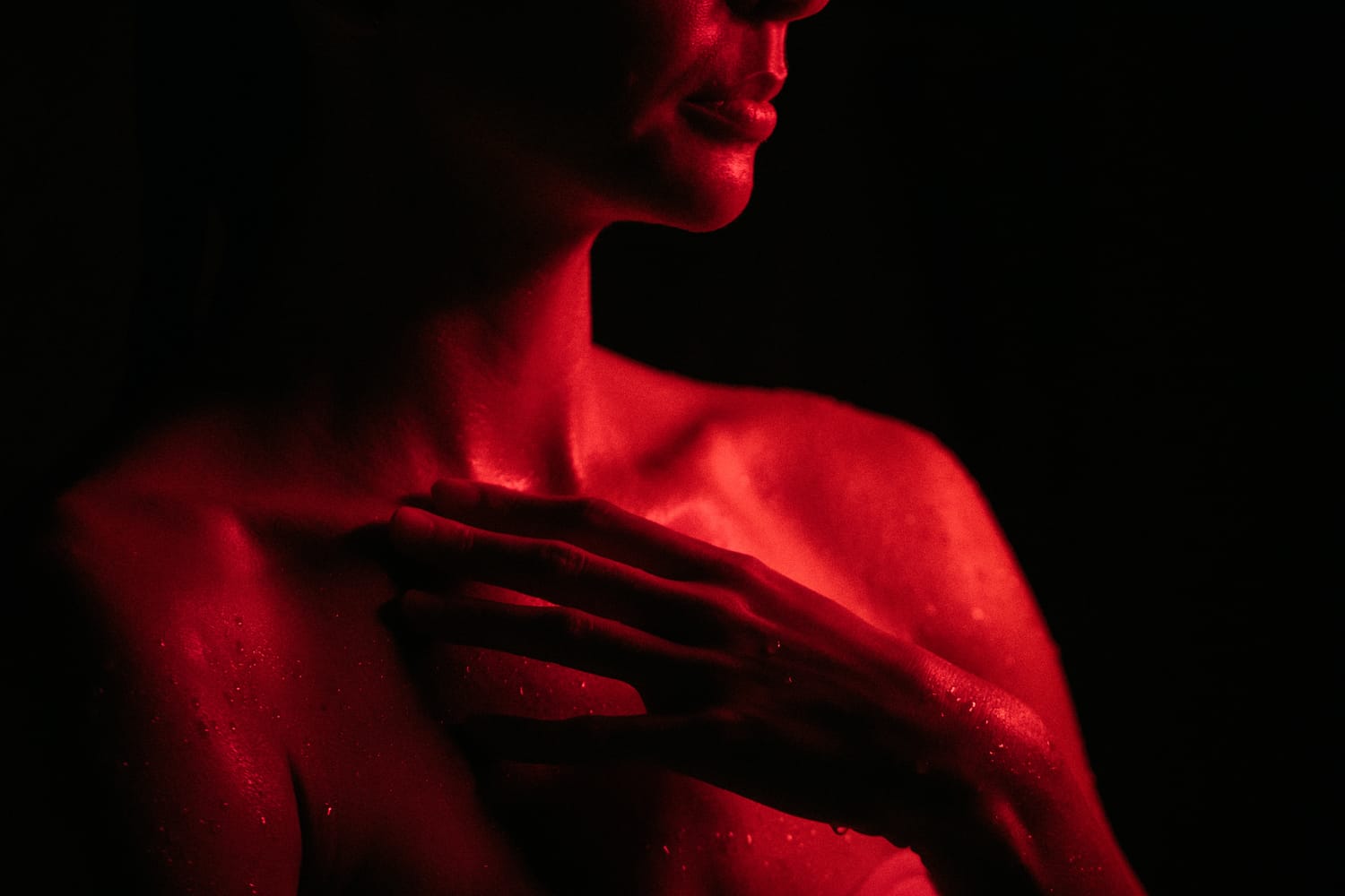 Angela at Float Space portraits story frame 22: A Float Space portrait set that moves from clean wellness headshots into red low-key portraits, skin, shadow and close detail..