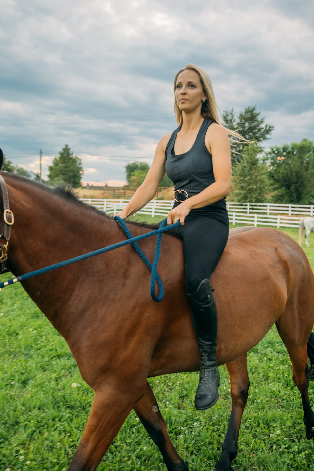 Ashton at the Ranch portraits story frame 1: Ranch portraits for Ashton in Kelowna, with horses, open pasture, quiet country styling and Okanagan light shaped into a grounded portrait story.