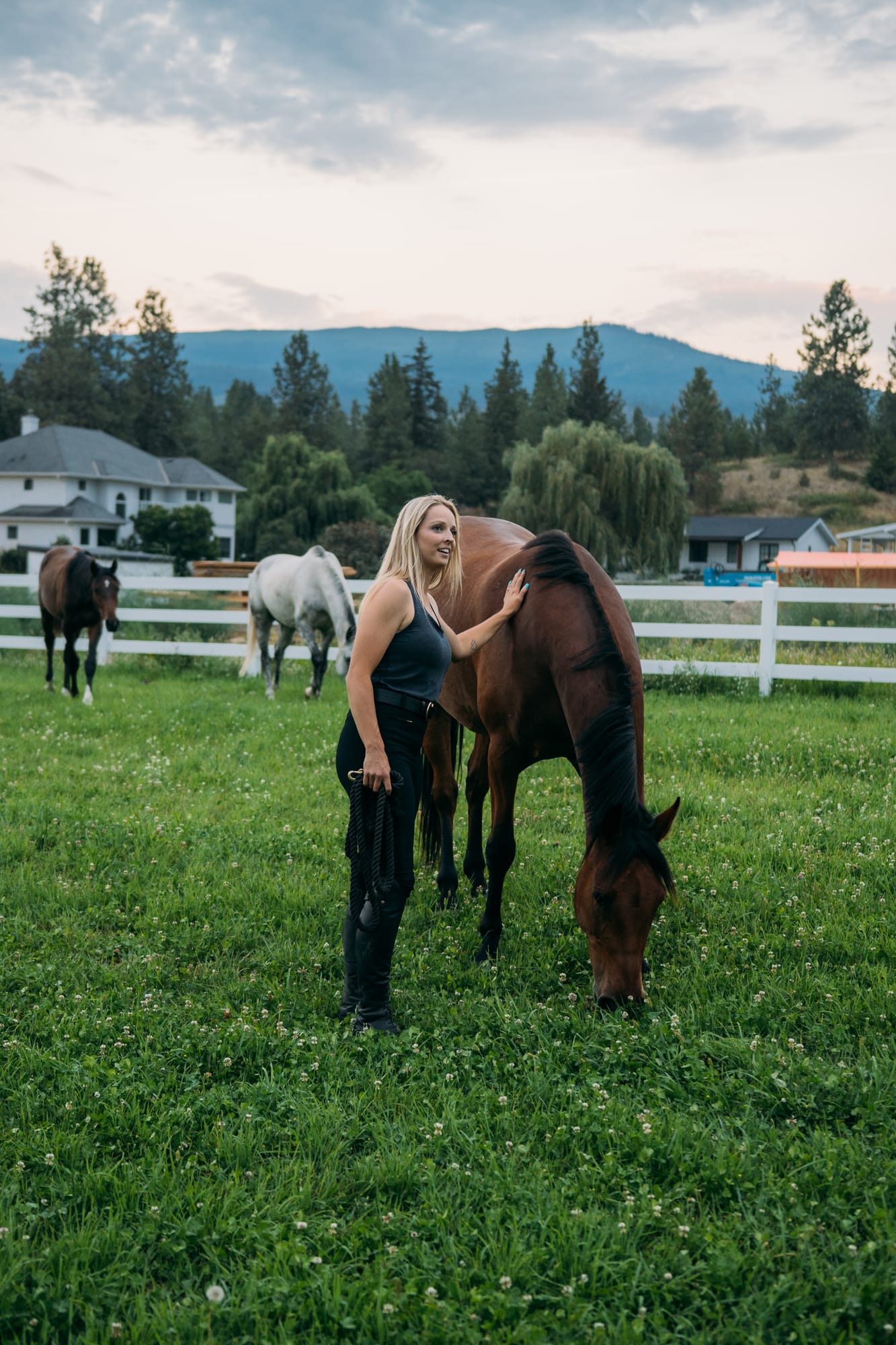 Ashton at the Ranch portraits story frame 14: Ranch portraits for Ashton in Kelowna, with horses, open pasture, quiet country styling and Okanagan light shaped into a grounded portrait story.