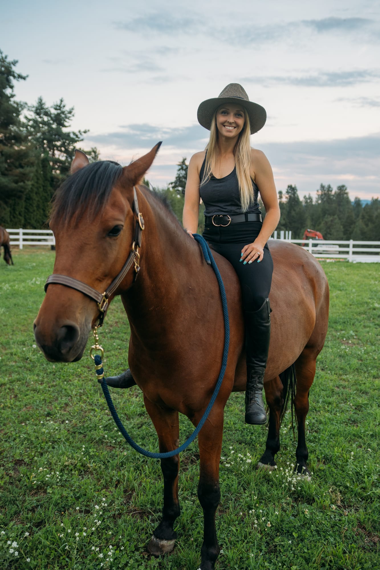 Ashton at the Ranch portraits story frame 24: Ranch portraits for Ashton in Kelowna, with horses, open pasture, quiet country styling and Okanagan light shaped into a grounded portrait story.