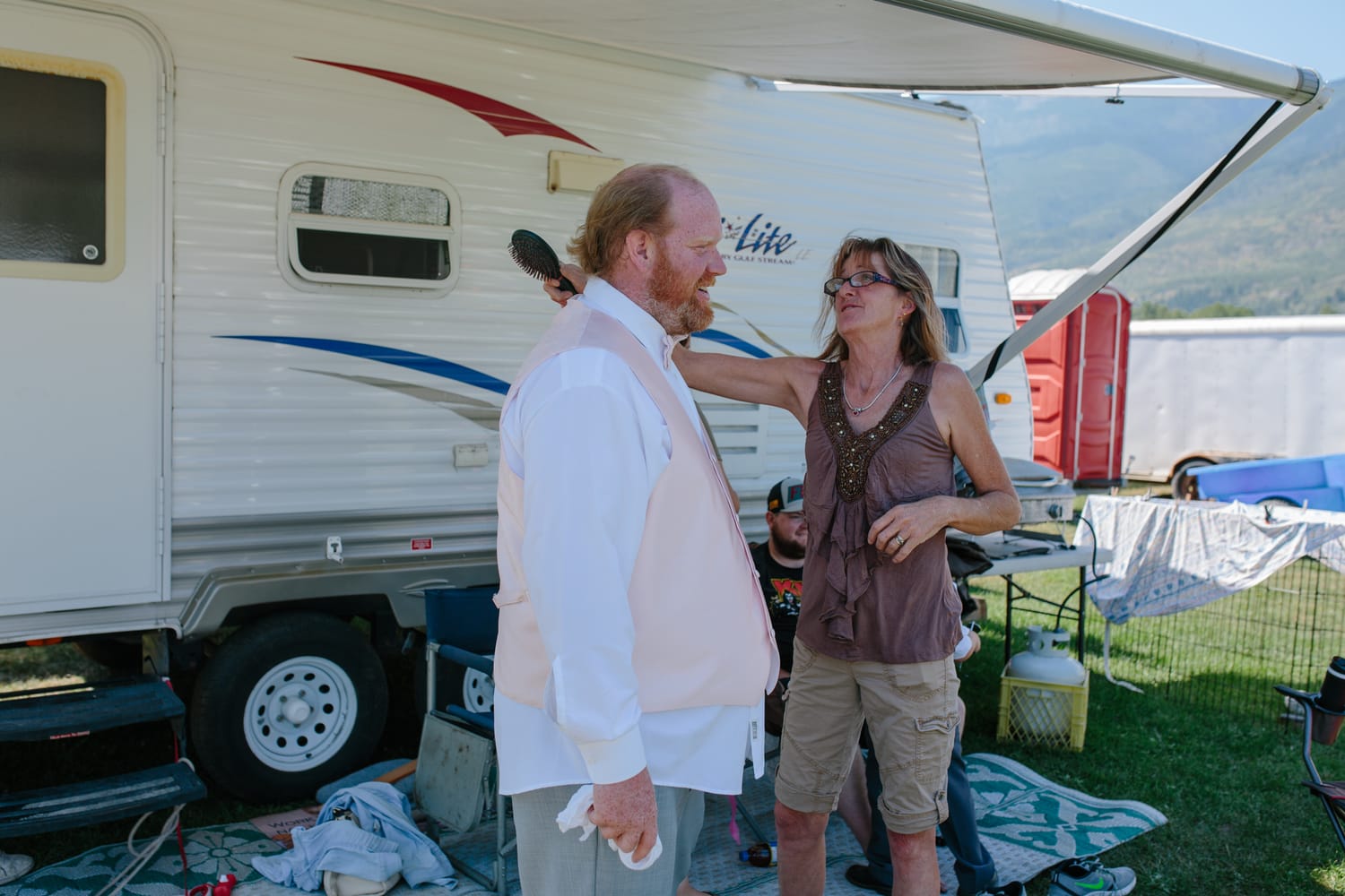Barbara and Ryan weddings story frame 4: A Salmon Arm wedding near Mount Ida, moving from a private yard to Marine Peace Park and wharf portraits, with the groom's trucking life part of the story..