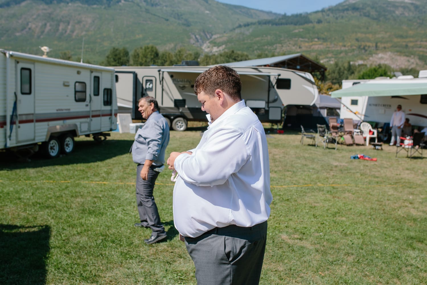 Barbara and Ryan weddings story frame 5: A Salmon Arm wedding near Mount Ida, moving from a private yard to Marine Peace Park and wharf portraits, with the groom's trucking life part of the story..