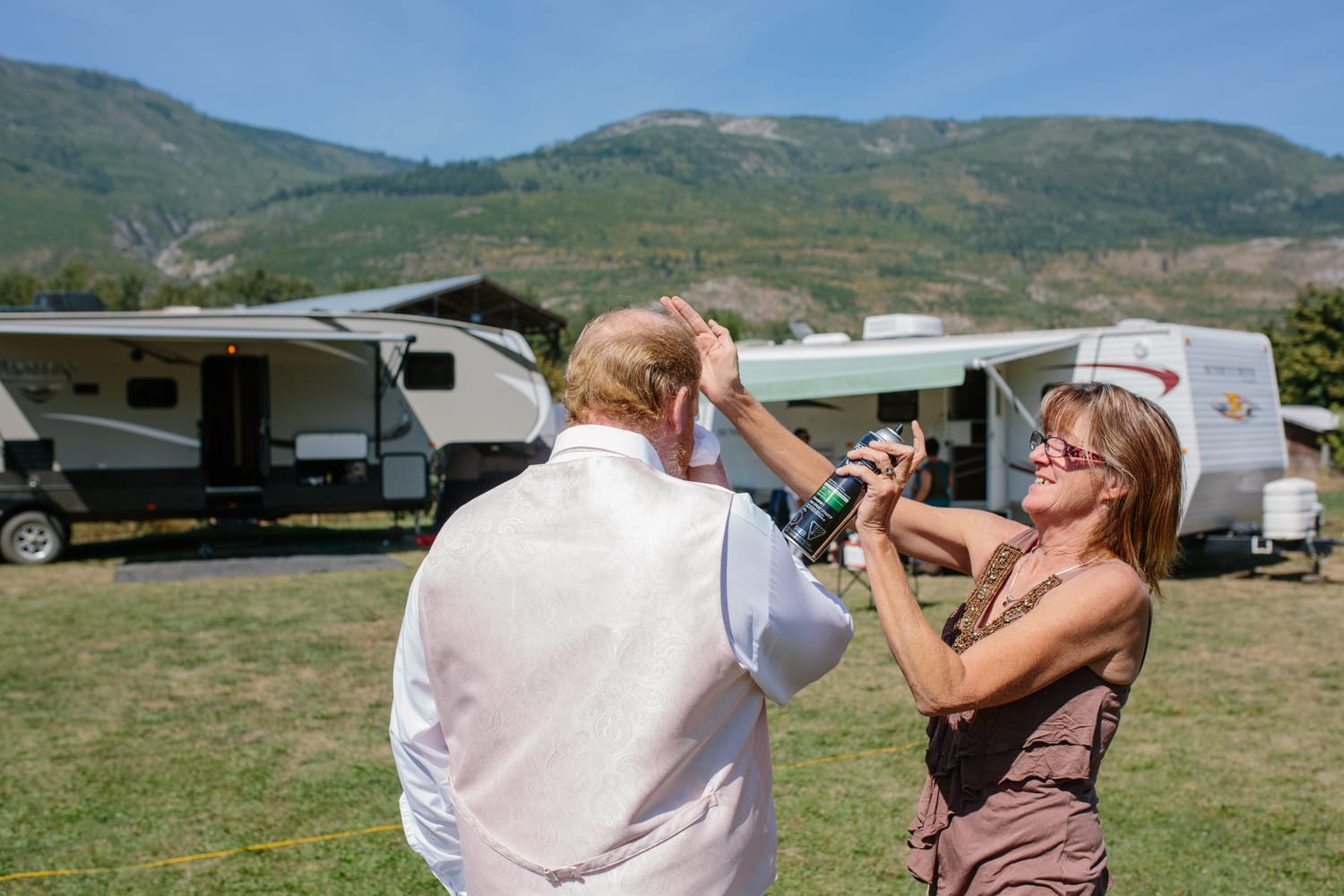 Barbara and Ryan weddings story frame 6: A Salmon Arm wedding near Mount Ida, moving from a private yard to Marine Peace Park and wharf portraits, with the groom's trucking life part of the story..