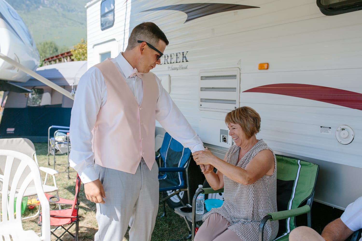 Barbara and Ryan weddings story frame 7: A Salmon Arm wedding near Mount Ida, moving from a private yard to Marine Peace Park and wharf portraits, with the groom's trucking life part of the story..