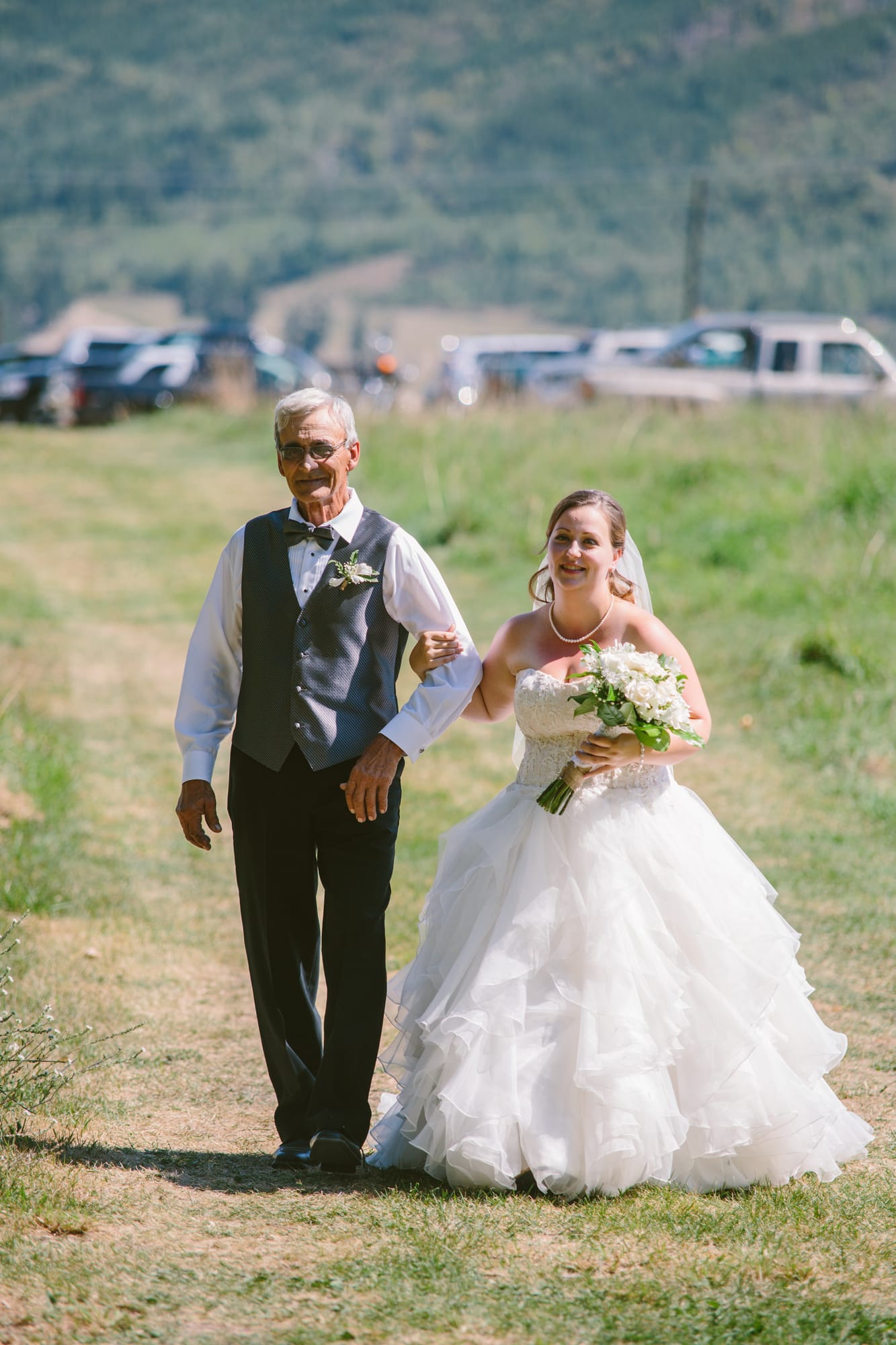 Barbara and Ryan weddings story frame 10: A Salmon Arm wedding near Mount Ida, moving from a private yard to Marine Peace Park and wharf portraits, with the groom's trucking life part of the story..