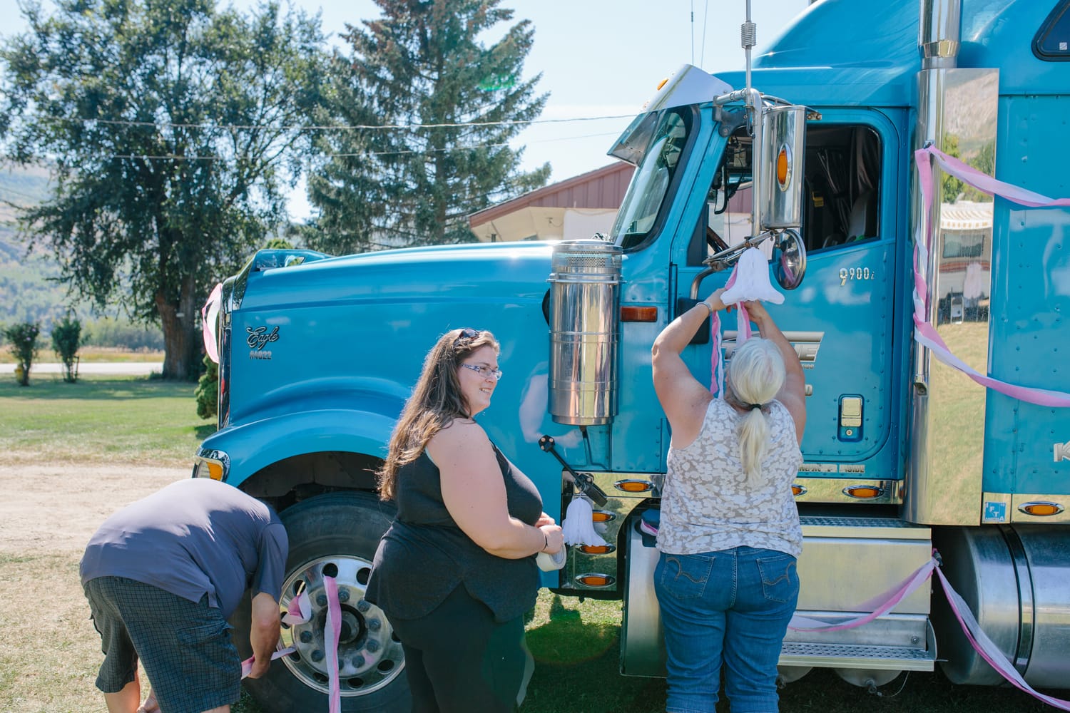 Barbara and Ryan weddings story frame 11: A Salmon Arm wedding near Mount Ida, moving from a private yard to Marine Peace Park and wharf portraits, with the groom's trucking life part of the story..