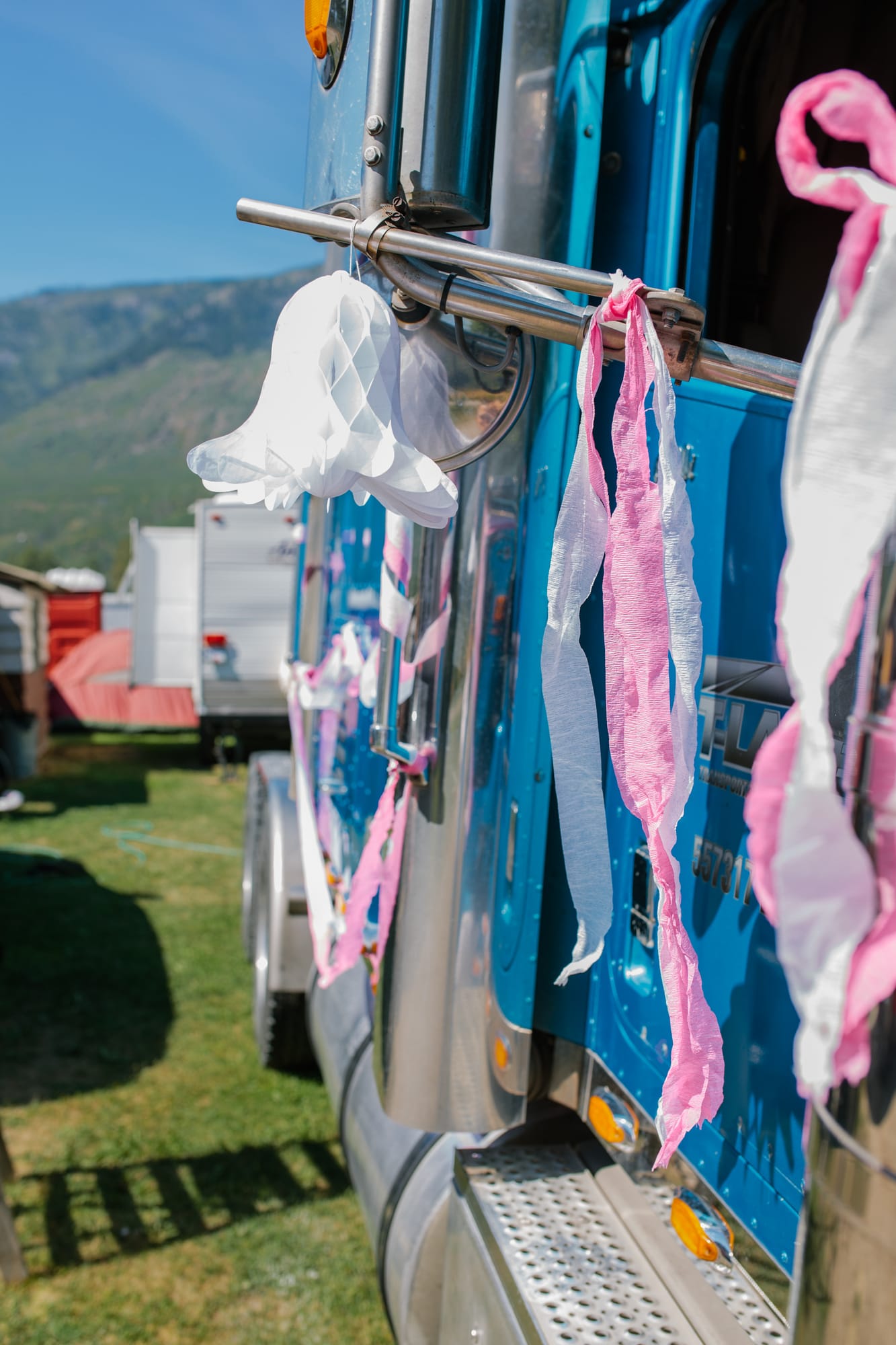 Barbara and Ryan weddings story frame 12: A Salmon Arm wedding near Mount Ida, moving from a private yard to Marine Peace Park and wharf portraits, with the groom's trucking life part of the story..