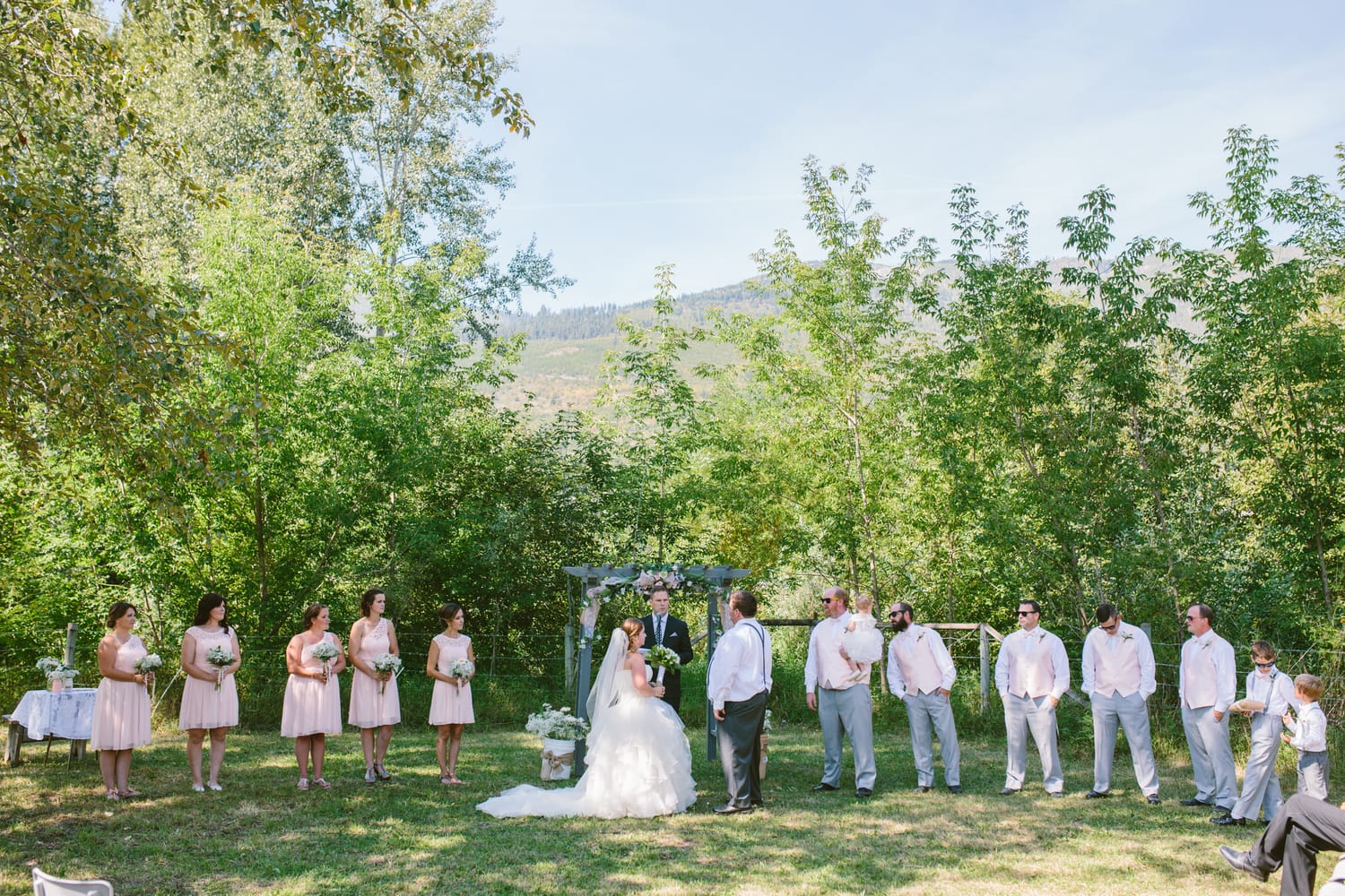 Barbara and Ryan weddings story frame 14: A Salmon Arm wedding near Mount Ida, moving from a private yard to Marine Peace Park and wharf portraits, with the groom's trucking life part of the story..
