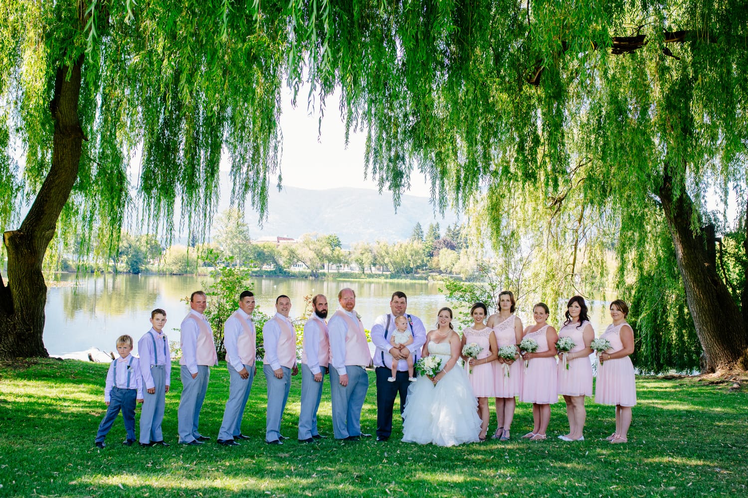 Barbara and Ryan weddings story frame 24: A Salmon Arm wedding near Mount Ida, moving from a private yard to Marine Peace Park and wharf portraits, with the groom's trucking life part of the story..