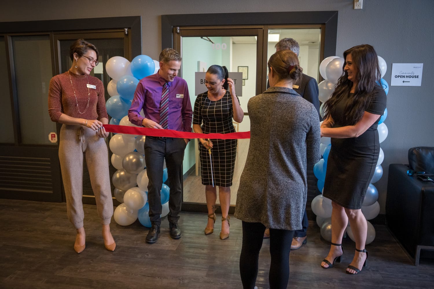 BrainTrust Canada Grand Opening corporate story frame 6: Event photography for BrainTrust Canada's Kelowna grand opening, with ribbon cutting, guests, office details, local food and exterior images for community and nonprofit communications..