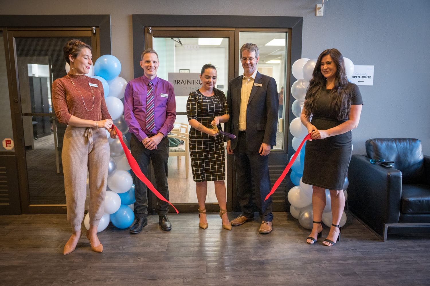 BrainTrust Canada Grand Opening corporate story frame 9: Event photography for BrainTrust Canada's Kelowna grand opening, with ribbon cutting, guests, office details, local food and exterior images for community and nonprofit communications..