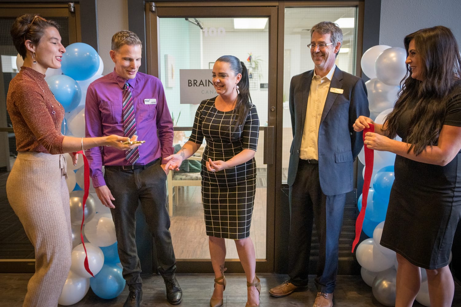 BrainTrust Canada Grand Opening corporate story frame 10: Event photography for BrainTrust Canada's Kelowna grand opening, with ribbon cutting, guests, office details, local food and exterior images for community and nonprofit communications..