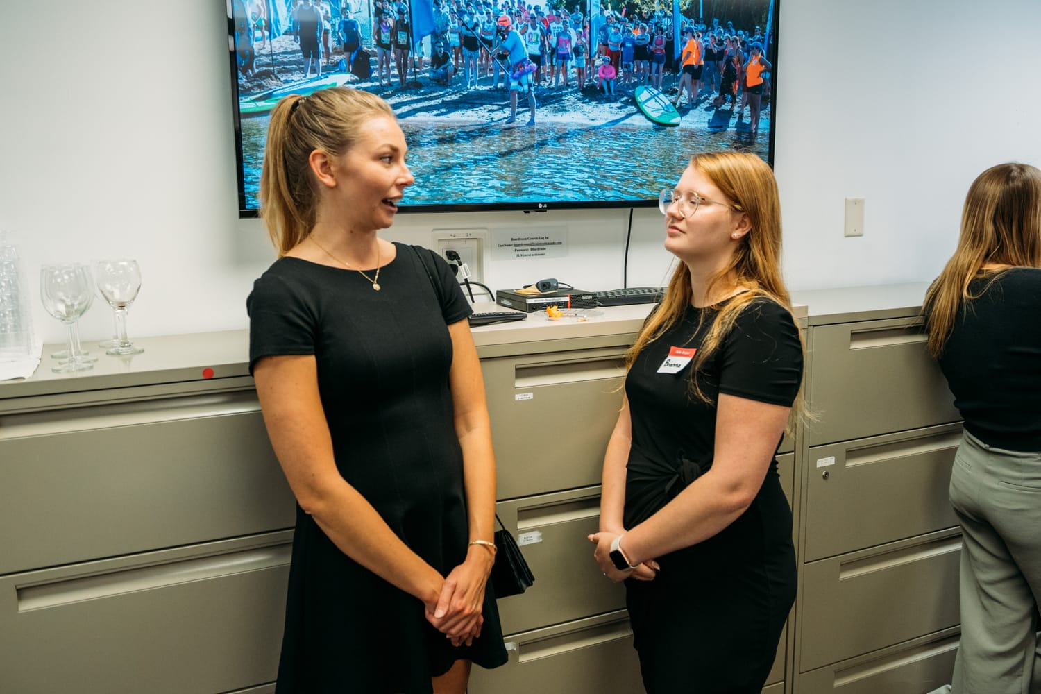 BrainTrust Canada Grand Opening corporate story frame 17: Event photography for BrainTrust Canada's Kelowna grand opening, with ribbon cutting, guests, office details, local food and exterior images for community and nonprofit communications..