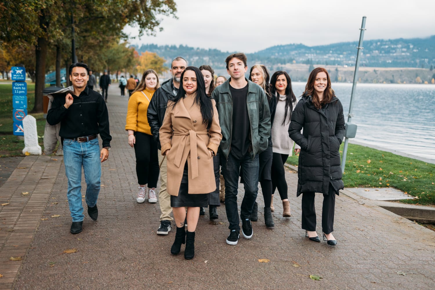 BrainTrust Canada Waterfront corporate story frame 20: Waterfront team and brand portraits for BrainTrust Canada in Kelowna, built around group photos, walking images and approachable nonprofit profile photography..