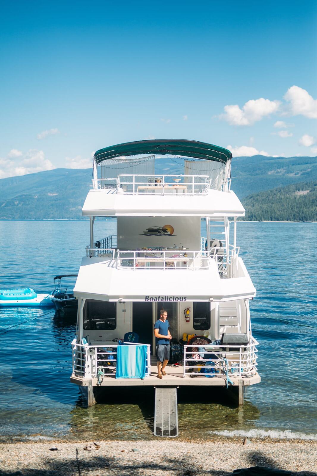 Carmel and Chris weddings story frame 4: A Sicamous and Shuswap Lake houseboat wedding that moved from water to beach, with friend-community overlap and a relaxed lakeside feeling..