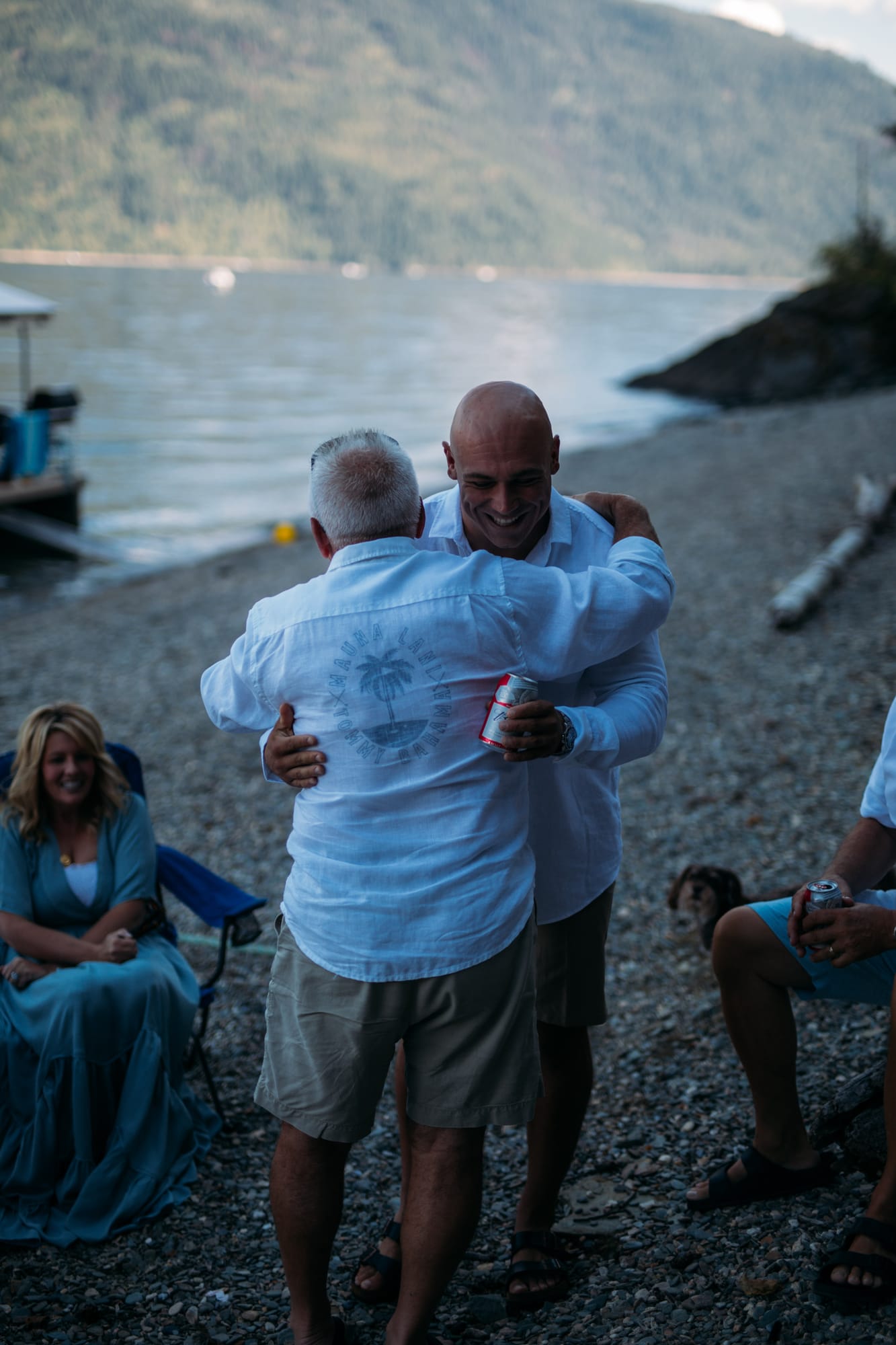 Carmel and Chris weddings story frame 11: A Sicamous and Shuswap Lake houseboat wedding that moved from water to beach, with friend-community overlap and a relaxed lakeside feeling..