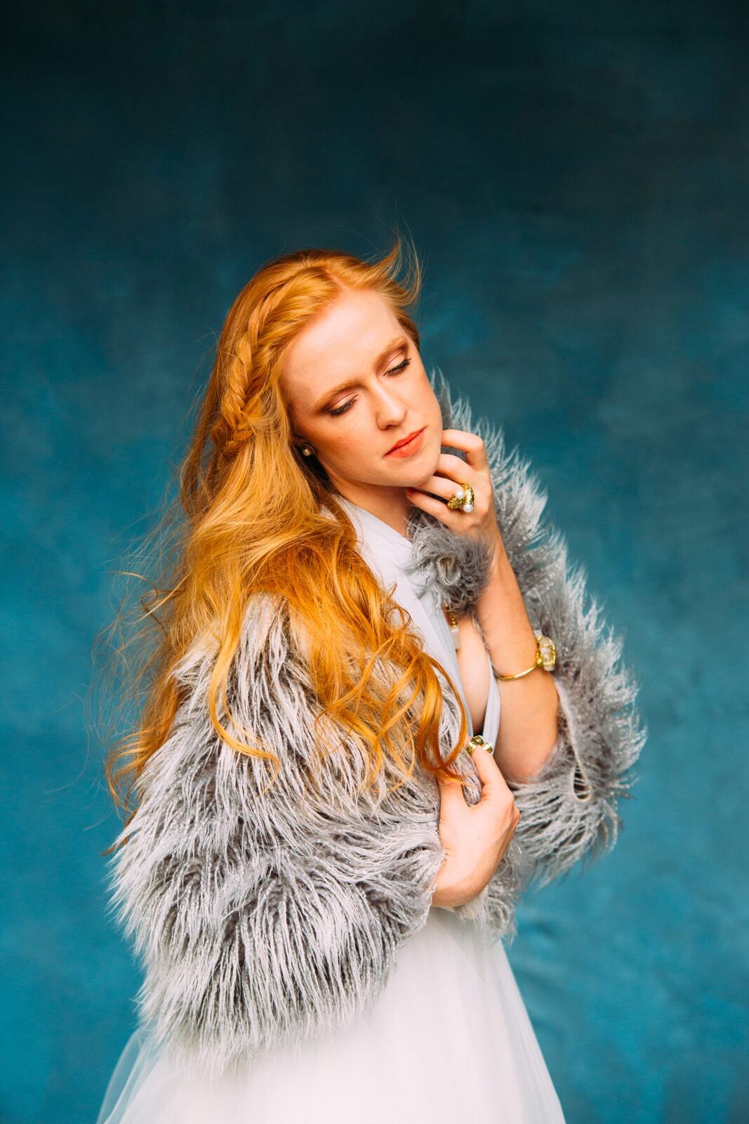 Catherine portraits story frame 10: Fashion portraits with Catherine from a White Willow Photography-designed collaboration near Salmon Arm, with pale blue styling, jewellery, veil and a painted studio backdrop.
