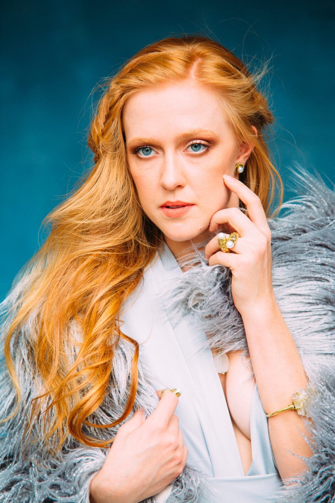 Catherine portraits story frame 13: Fashion portraits with Catherine from a White Willow Photography-designed collaboration near Salmon Arm, with pale blue styling, jewellery, veil and a painted studio backdrop.