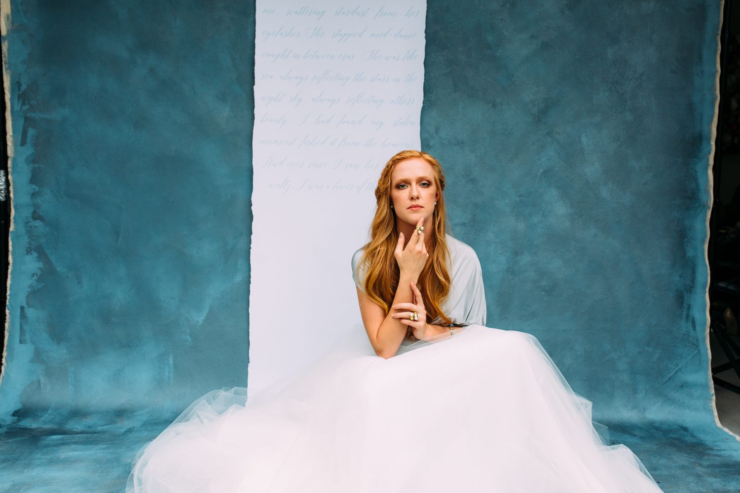 Catherine portraits story frame 19: Fashion portraits with Catherine from a White Willow Photography-designed collaboration near Salmon Arm, with pale blue styling, jewellery, veil and a painted studio backdrop.