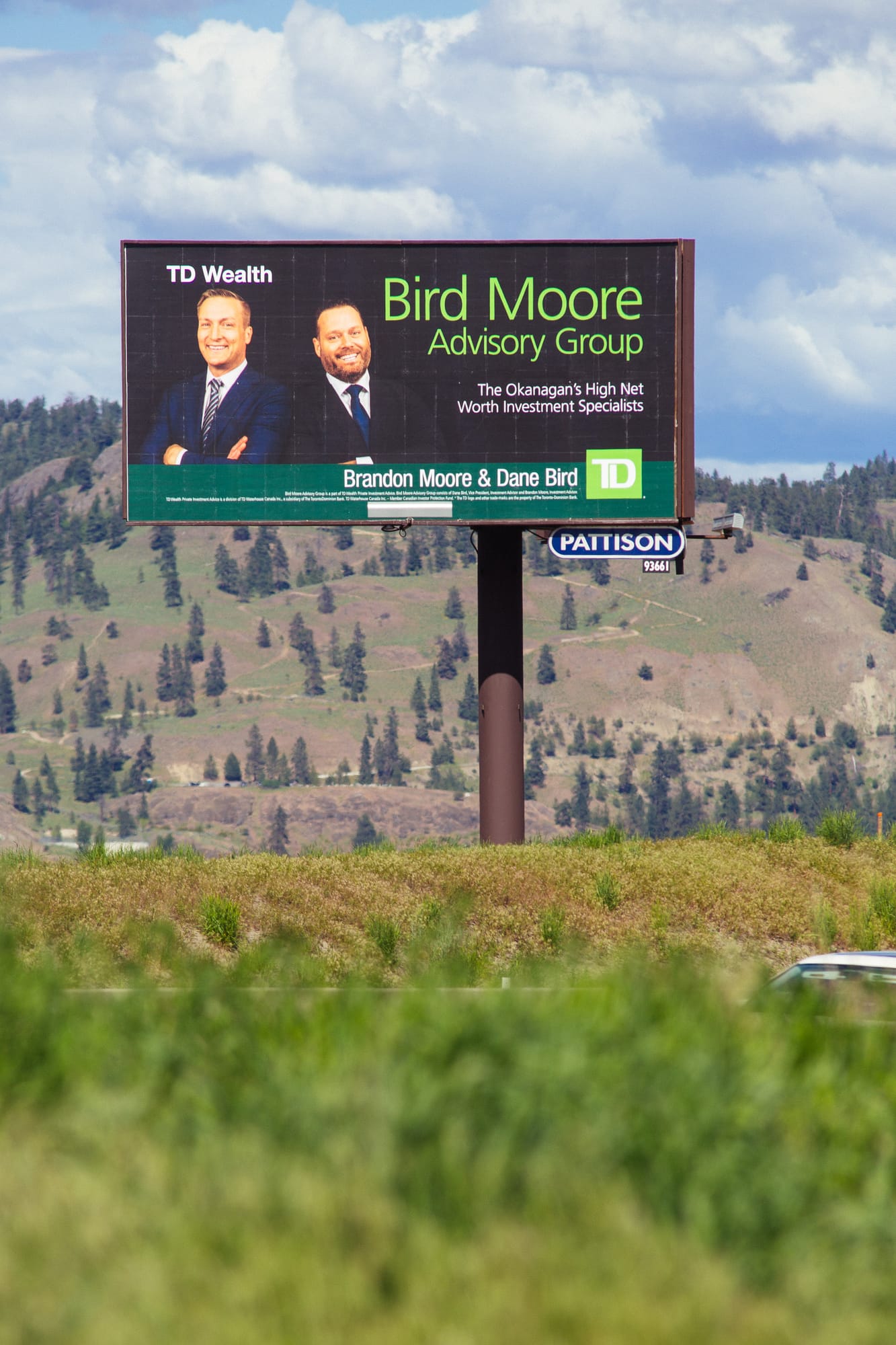 Bird Moore corporate story frame 5: Dark-background business portraits and billboard proof for Bird Moore in Kelowna, with profile imagery built for financial, advisory and local campaign use..