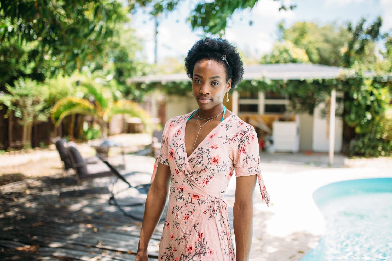 Dee-J by the Pool in Miami portraits story frame 4: Poolside portraits with Dee-J Spaulding in Miami, moving through direct expression, swimwear details, bright water and warm Florida light.