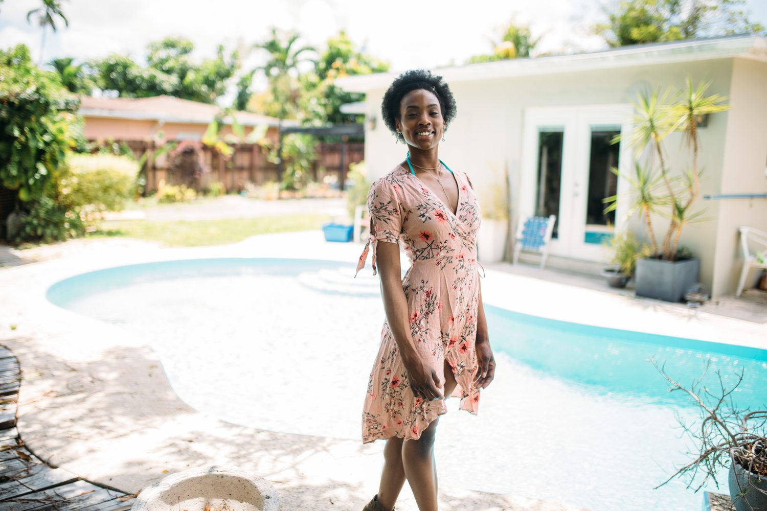 Dee-J by the Pool in Miami portraits story frame 5: Poolside portraits with Dee-J Spaulding in Miami, moving through direct expression, swimwear details, bright water and warm Florida light.