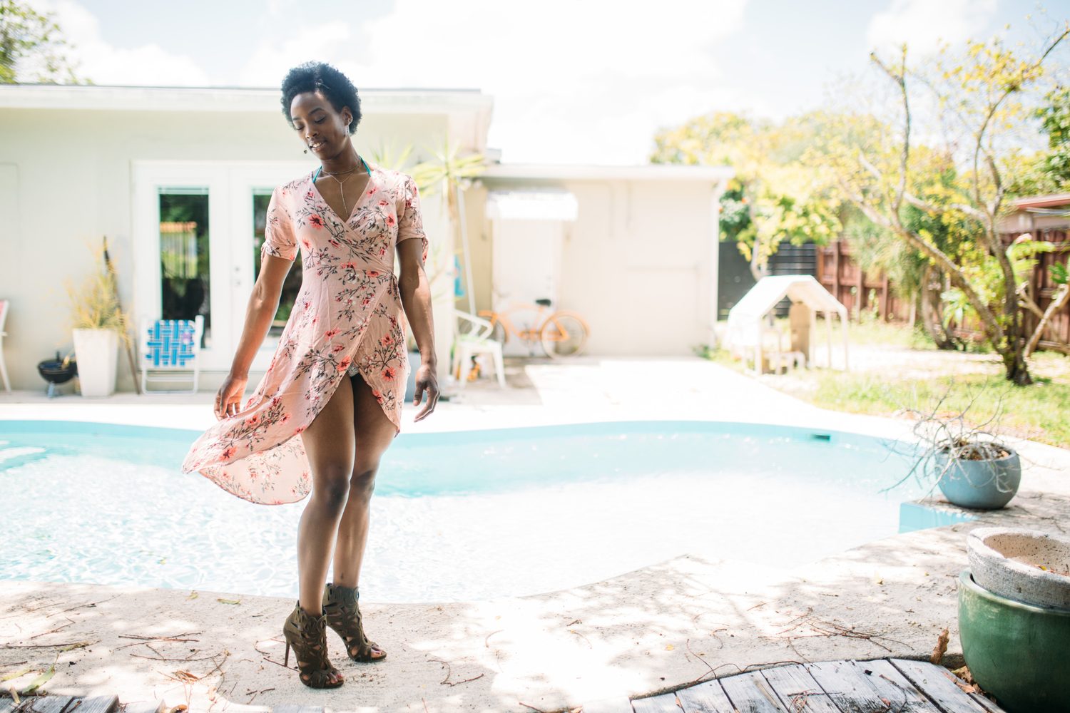 Dee-J by the Pool in Miami portraits story frame 6: Poolside portraits with Dee-J Spaulding in Miami, moving through direct expression, swimwear details, bright water and warm Florida light.