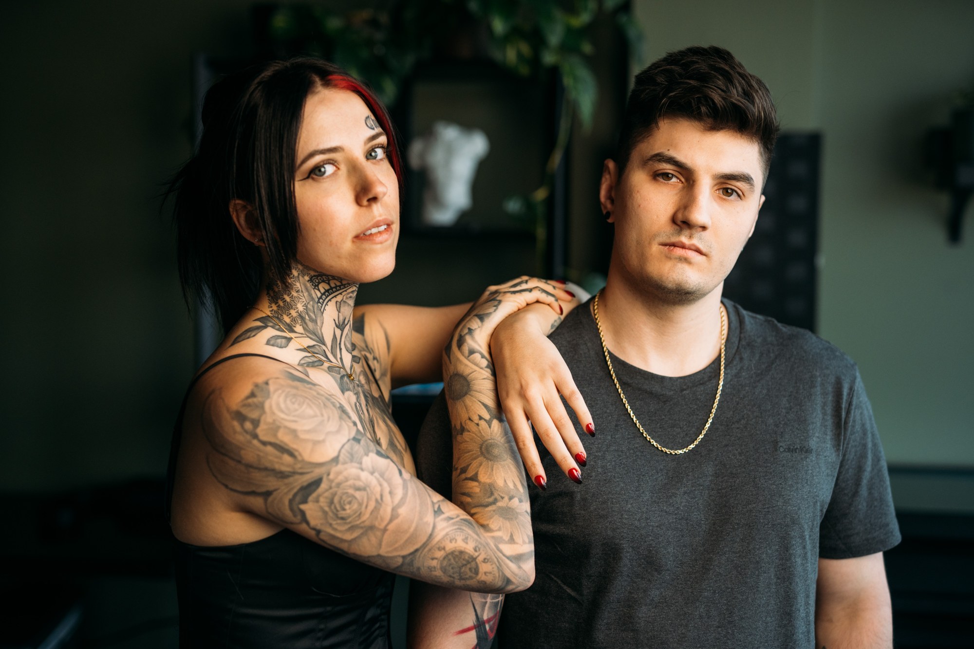 District Ink: Close paired portrait in the dark teal room.