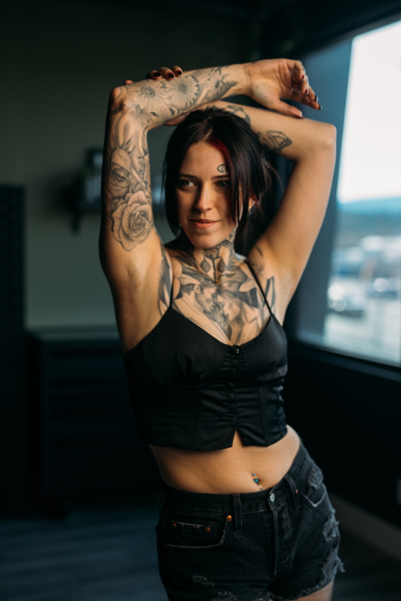 District Ink: Raised-arm portrait showing the tattoo work.