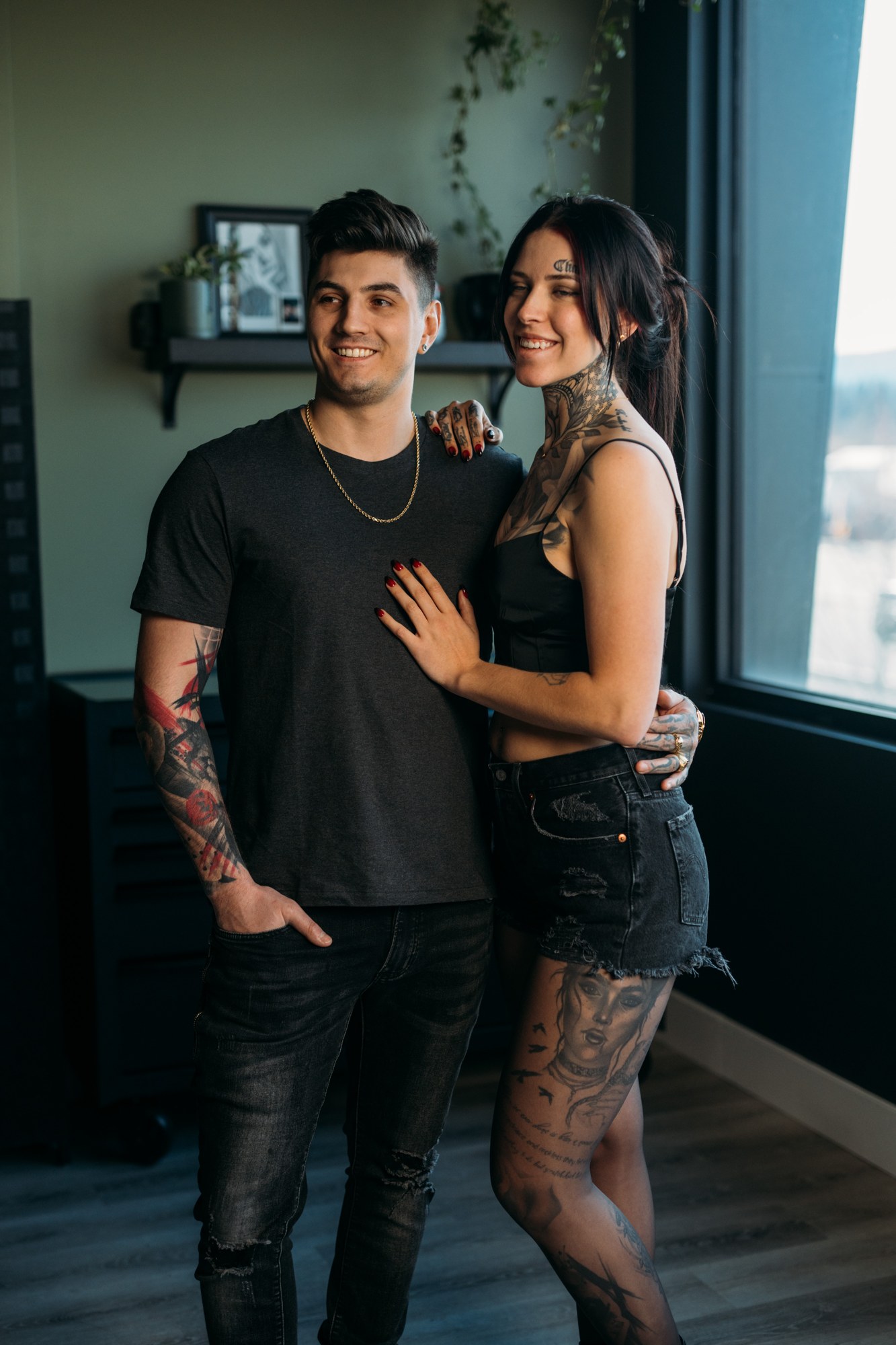 Two people smiling together in the District Ink studio.