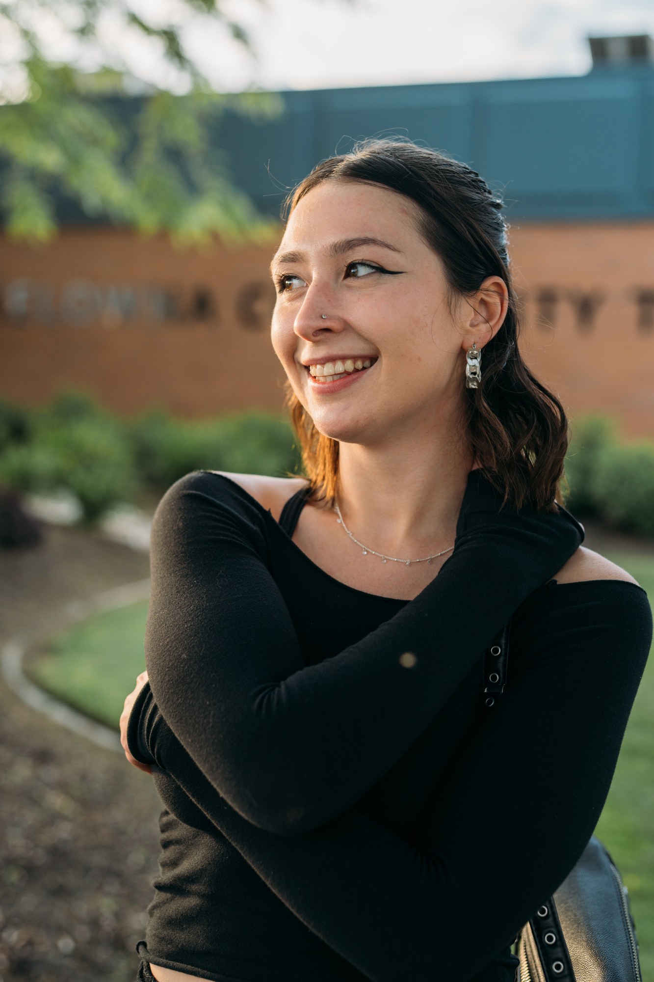 Diva Den Team Portraits: Abby smiling in conversation.