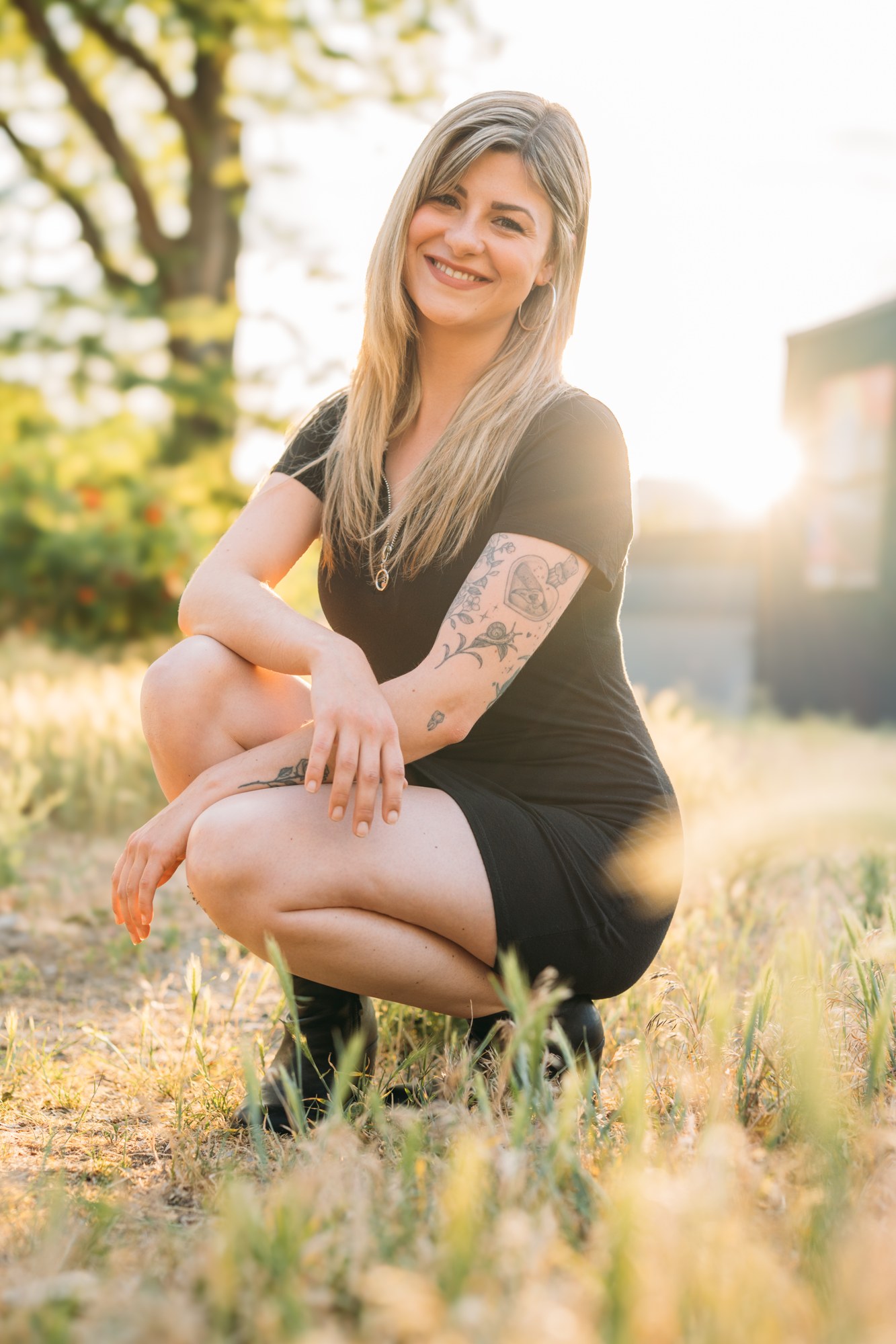 Diva Den Team Portraits: Sophia seated in the warm garden light.