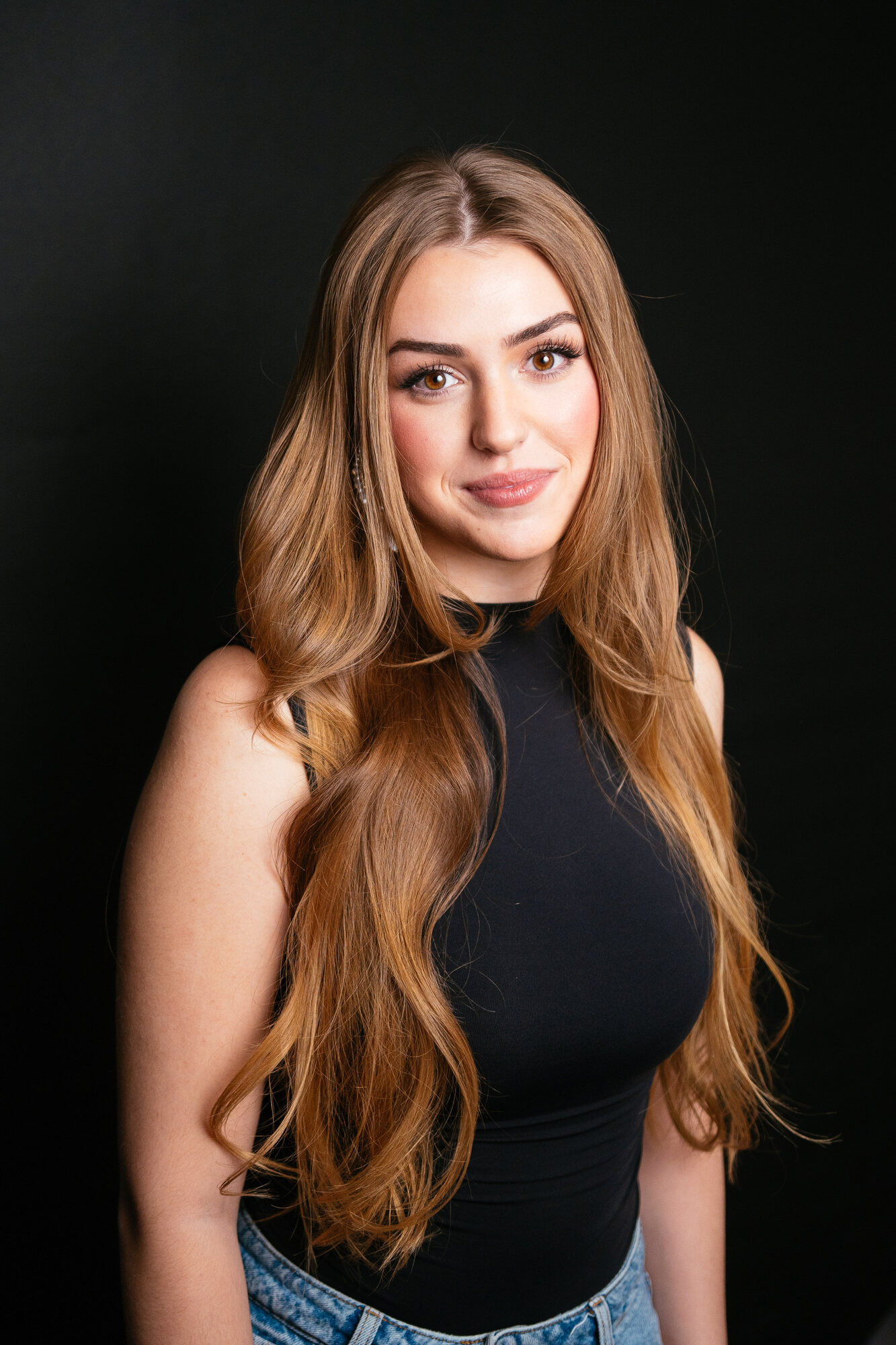 Elena black-backdrop headshot with black top