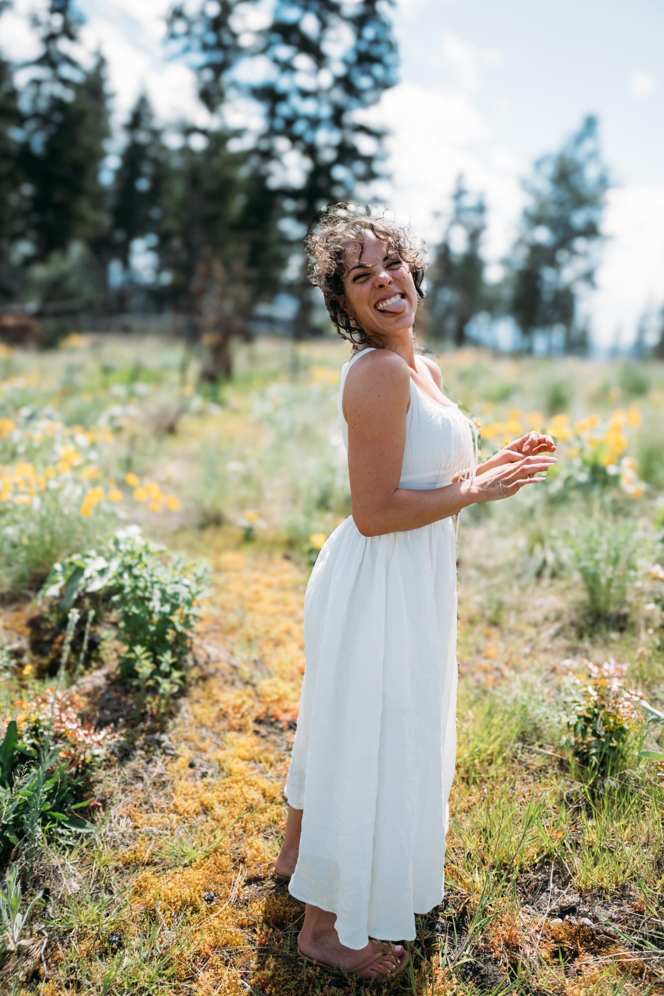 Giuliana at LoveReins portraits story frame 4: Equestrian portrait session at Love Reins Ranch in Lake Country, BC, with Giuliana, horses, white-dress portraits, Western cowgirl styling, ranch fencing, riding frames and warm Okanagan light..