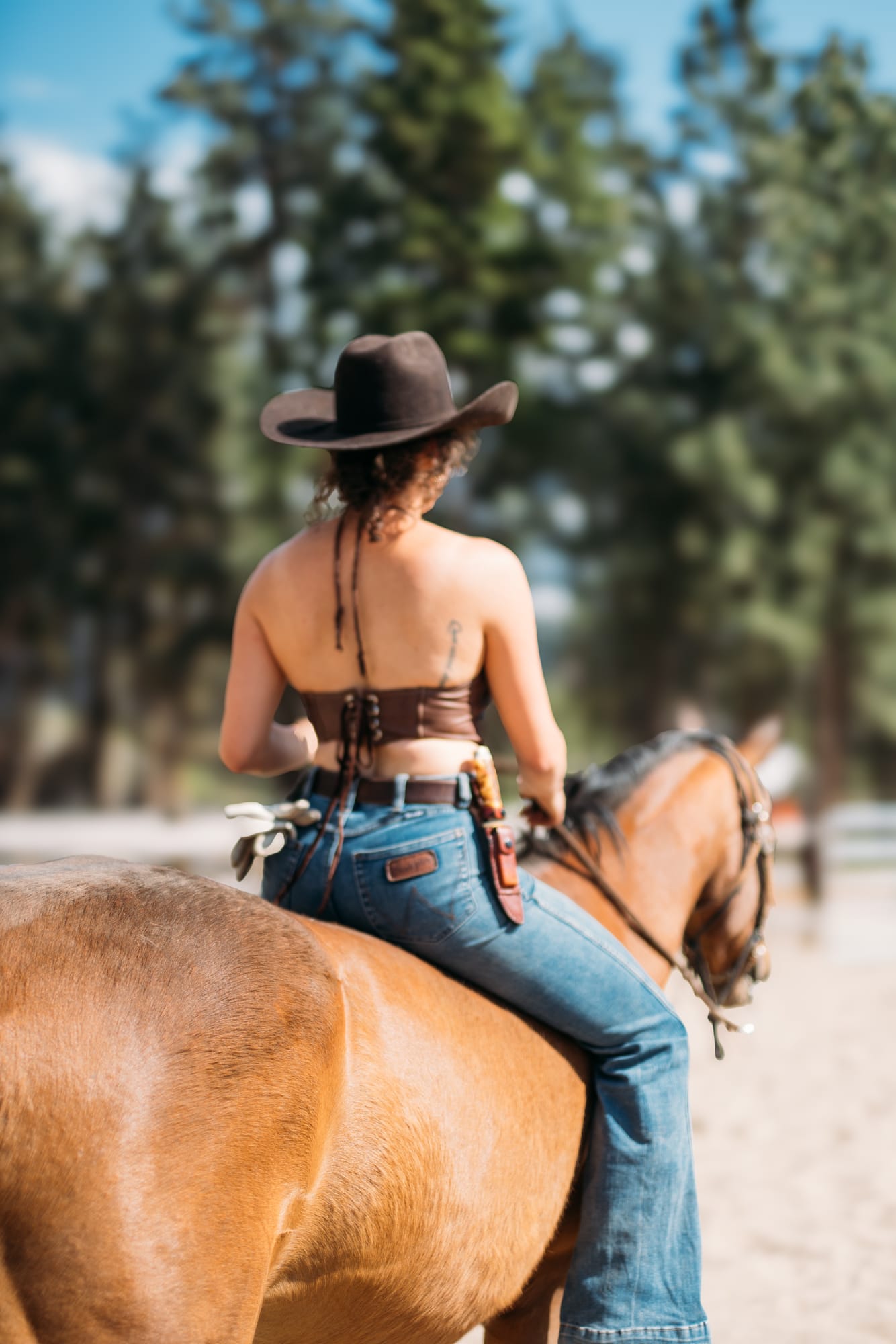Giuliana at LoveReins portraits story frame 16: Equestrian portrait session at Love Reins Ranch in Lake Country, BC, with Giuliana, horses, white-dress portraits, Western cowgirl styling, ranch fencing, riding frames and warm Okanagan light..